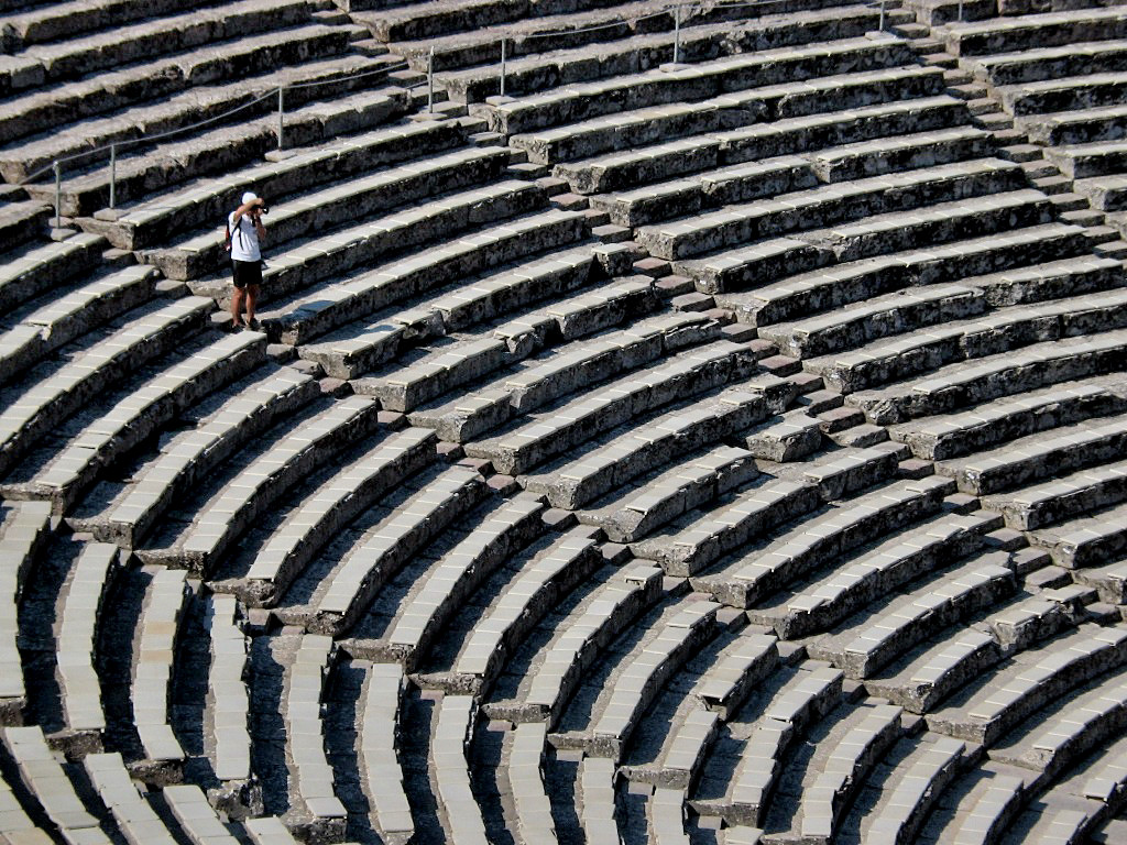 The outdoor Theatre of Epidaurus has the three main features of a Greek theatre: the orchestra, the skene, and the cavea.