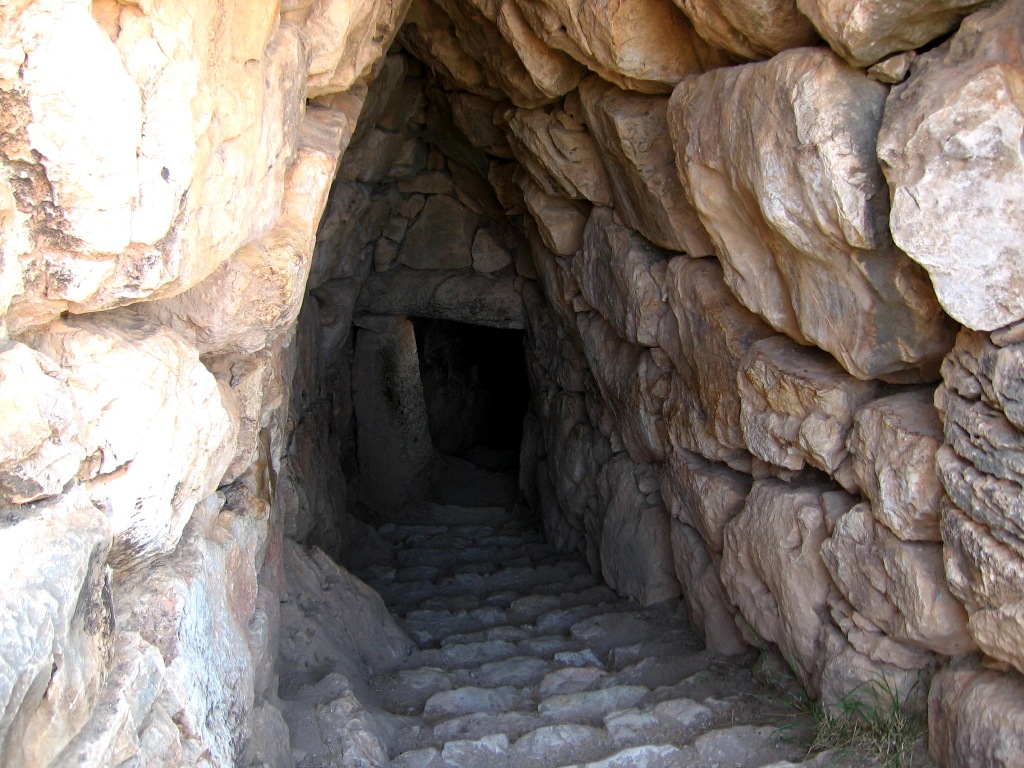 The tunnel passes down through and underneath the fortress walls of ancient Mycenae and continues on down toward the cistern, eighteen meters down, you reach the large cistern for water 