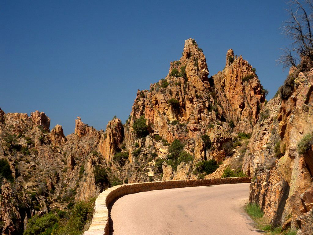 Curved road between stone towers of Calanques de Piana - Corsica 