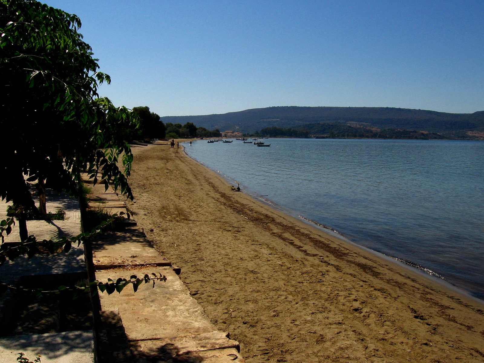 At most of the beaches around Gialova village, the sand slopes gently into the clear, blue water of Navarino Bay Pylos Greece 