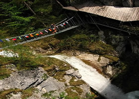 Walking over bridge above Tscheppa waterfall Austria